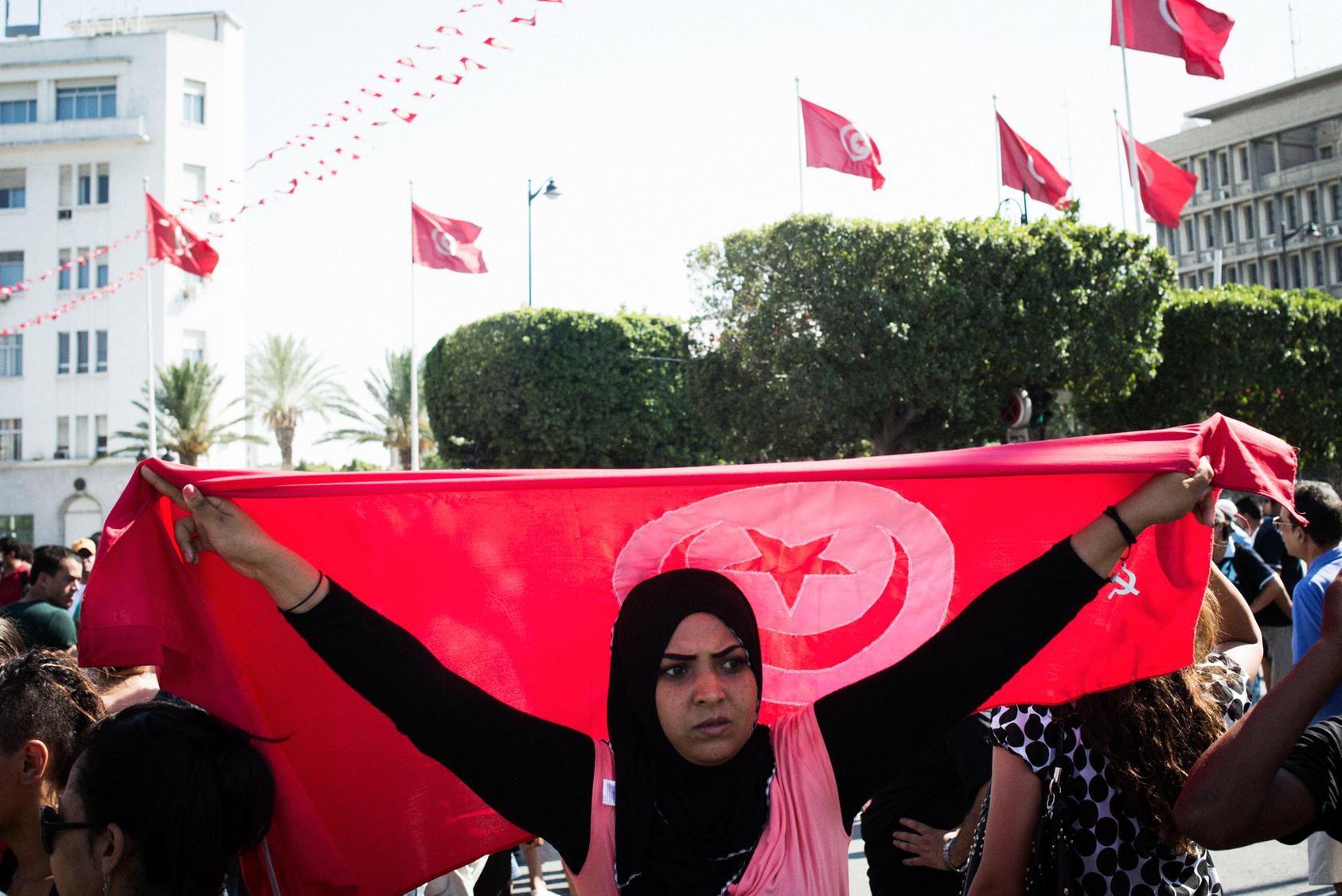 Female Protester Holding Tunisian Flag