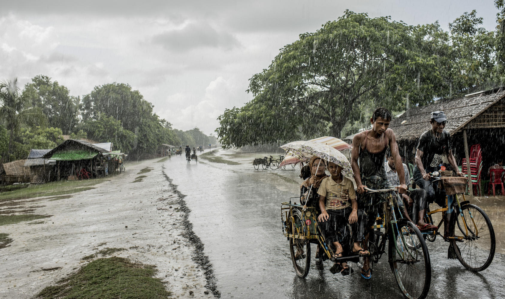Rickshaws during monsoon rains at a camp for Rohingya in Sittwe. The government says it is determined to stop the migrants fleeing religious persecution, but it will not address the conditions driving the exodus. Photo Courtesy of the New York Times/Tomas Munita