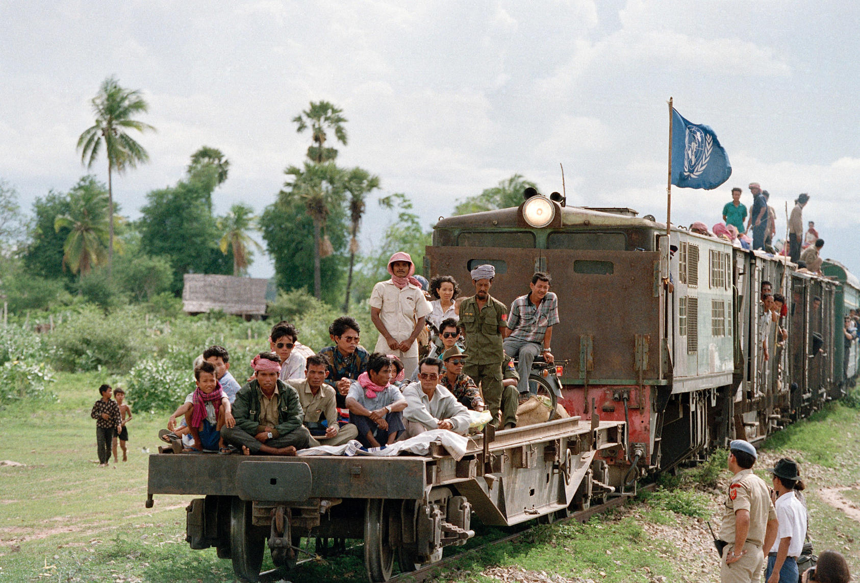 Cambodians returning from refugee camps in Thailand aboard a UNHCR train as it approaches Phnom Penh. 