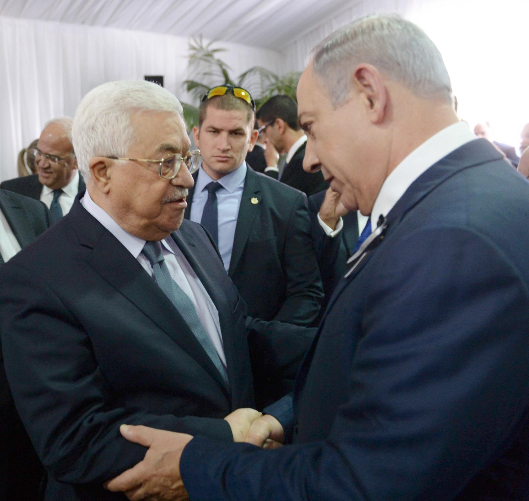 President Mahmoud Abbas, left, shakes hands with Israeli Prime Minister Benjamin Netanyahu
