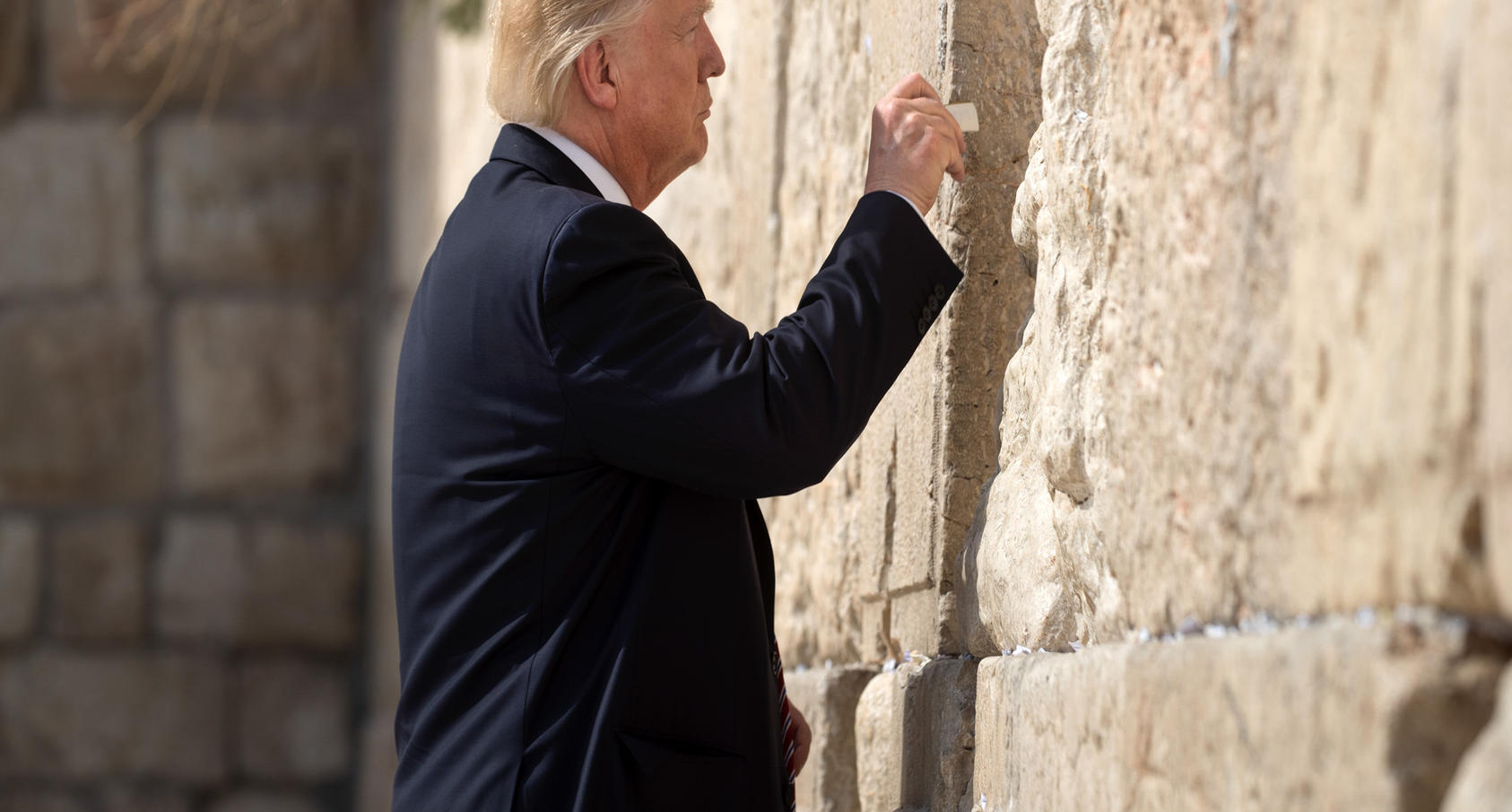 President Donald Trump places a paper into the Western Wall in Jerusalem, May 22, 2017. Photo Courtesy of The New York Times/Stephen Crowley