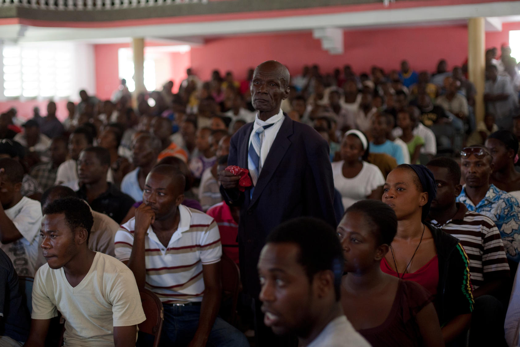 The audience of a courtroom during a trial of police officers, who are charged with murder or attempted murder in connection with a prison massacre last year, at the Catholic Cultural Center Saint-Louis in Les Cayes, Haiti, Oct. 26, 2011. The trial, now in its third week, is being used by Haiti's new government to show a new rule of law. (Andres Martinez Casares/The New York Times)