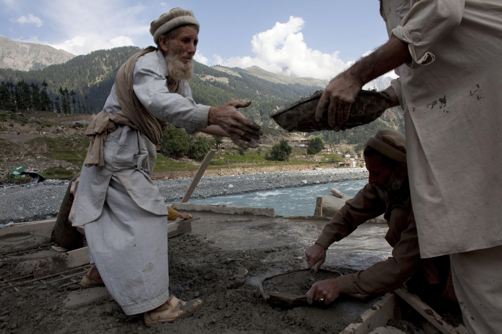 Pakistani men work to rebuild a bridge over a river in Kalam, a village in the Swat Valley formerly used by the Taliban, in Pakistan, Sept. 4, 2010. After scathing criticism that they were unprepared for the disaster and inept in their initial response, government officials, ministers and even President Asif Ali Zardari are crisscrossing flood-affected areas of the country in a frantic effort to ease public anger and despair.