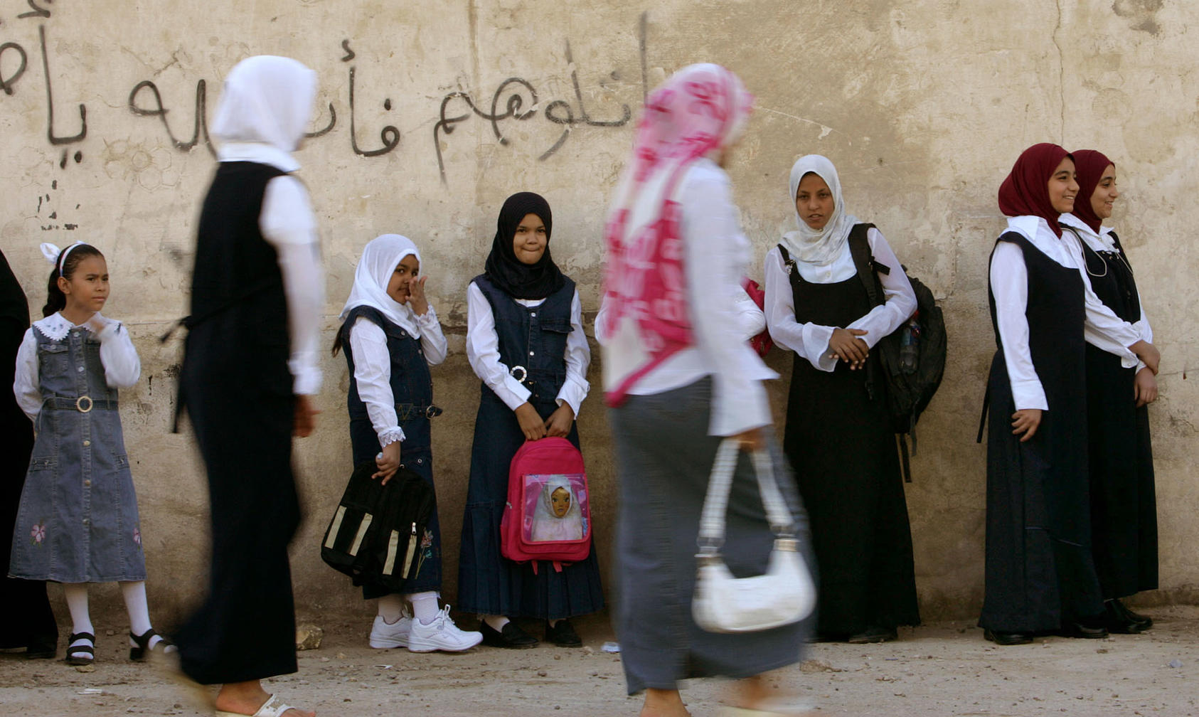 Girls wait to head to their classrooms at a school in Sadr City, the predominantly Shiite neighborhood of Baghdad, Wednesday, Sept. 20, 2006. Six million students nationwide returned to school on Wednesday morning after three months of summer vacations, according to Iraqi ministry of education.
