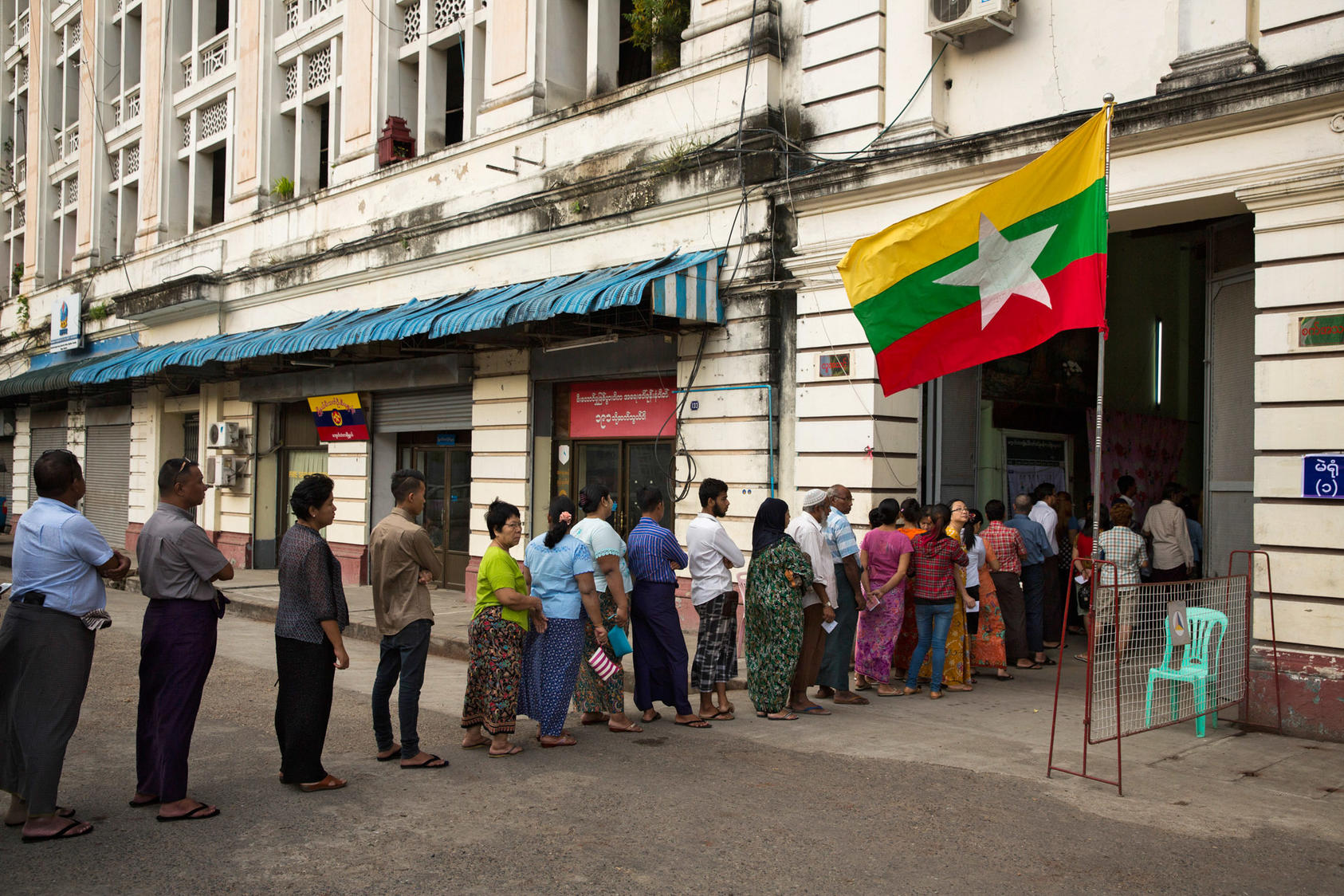 Voters line up outside a polling station in Yangon, Myanmar, Nov. 8, 2015. After five decades of military rule and a series of rigged or canceled elections, voters took part in what many described as their first genuine election. (Adam Dean/The New York Times)