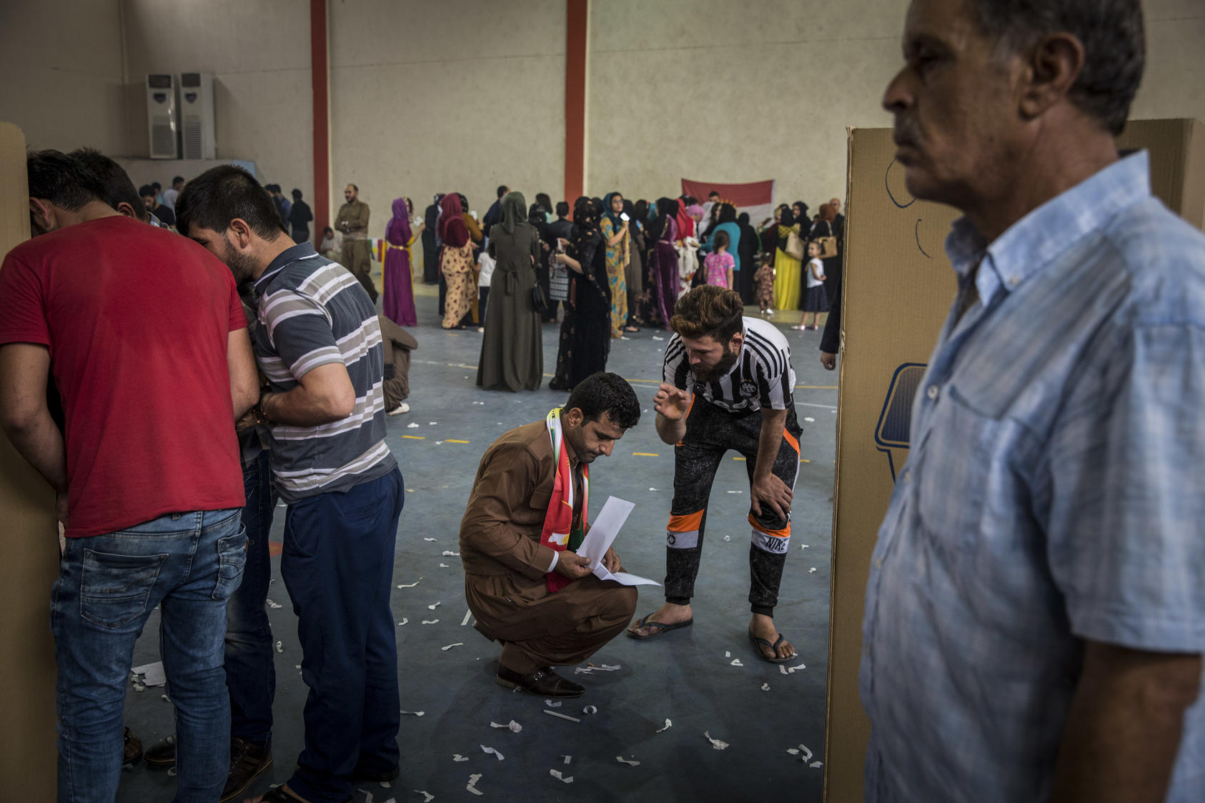 People vote in a referendum on independence, in a sports hall set up at a voting center in Erbil, Iraq, Sept. 25, 2017. Photo Courtesy of The New York Times/Ivor Prickett