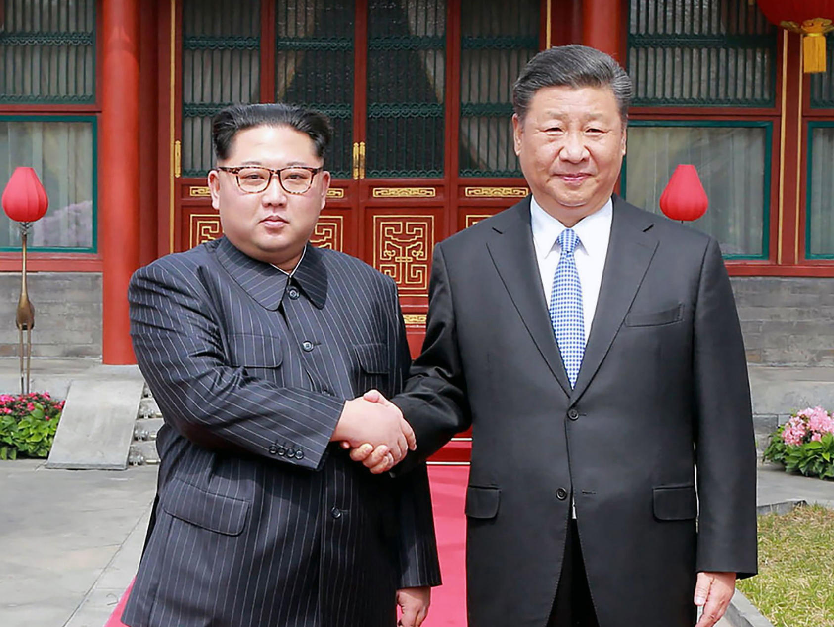 President Xi Jinping of China, right, shakes hands with Kim Jong Un, North Korea’s leader