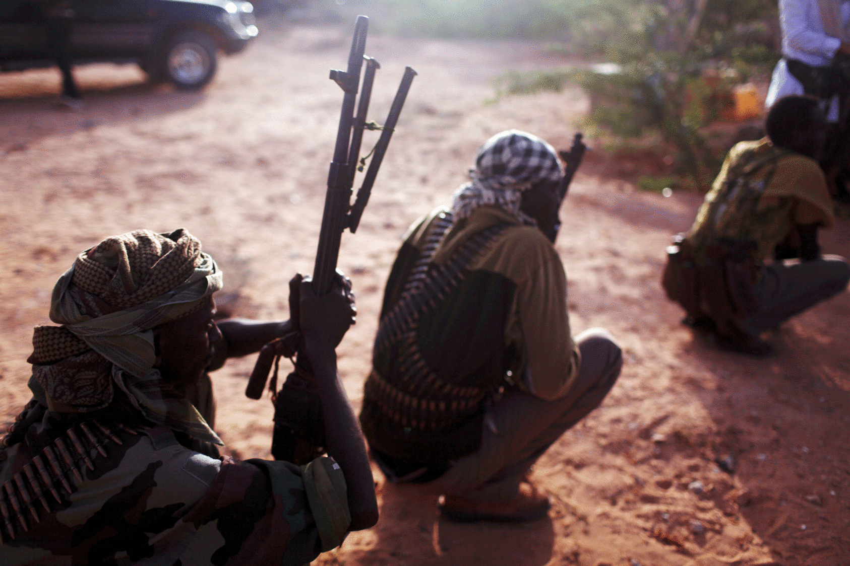At dawn, pirate militia men are briefed on the day's movements in Hobyo, Somalia