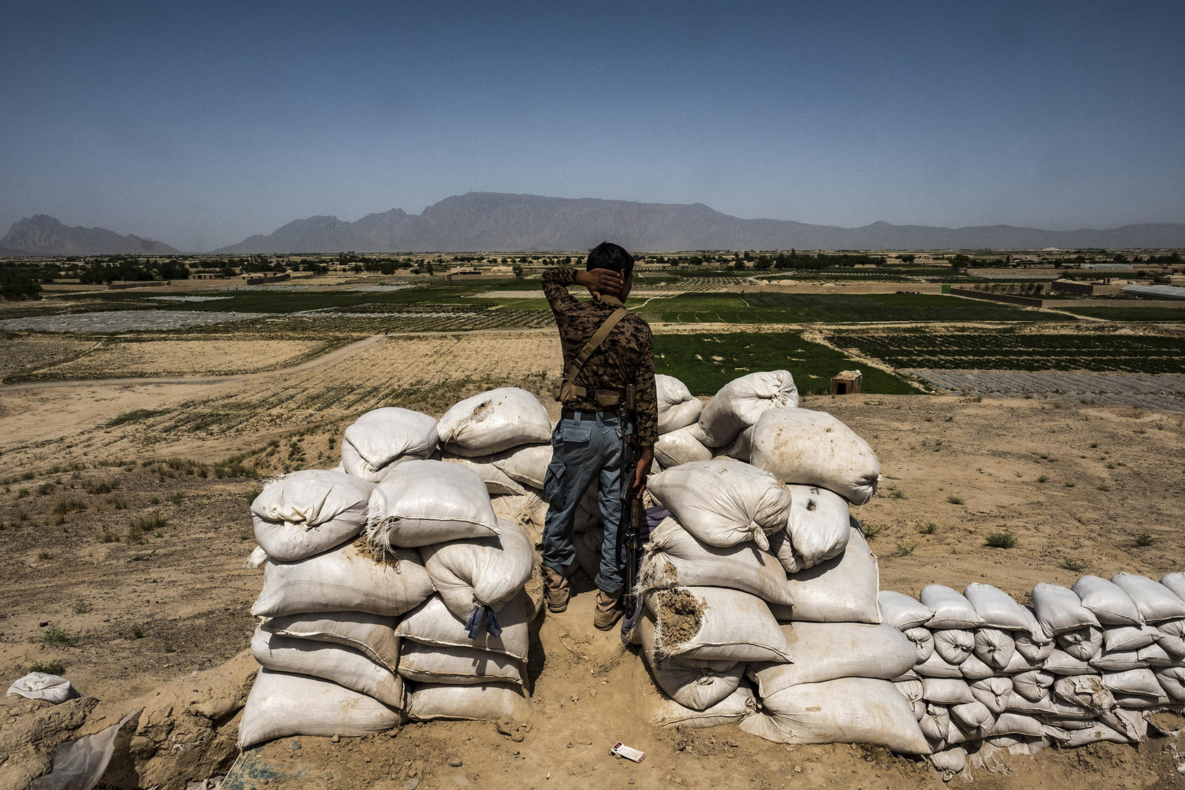 An Afghan police officer mans an outpost in Farah Province, near the border with Iran. (Bryan Denton/The New York Times)