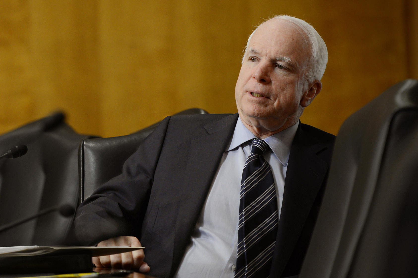 Senator John McCain listens to testimony from USIP staff member Andrew Wilder at a hearing on the war in Afghanistan in 2013.