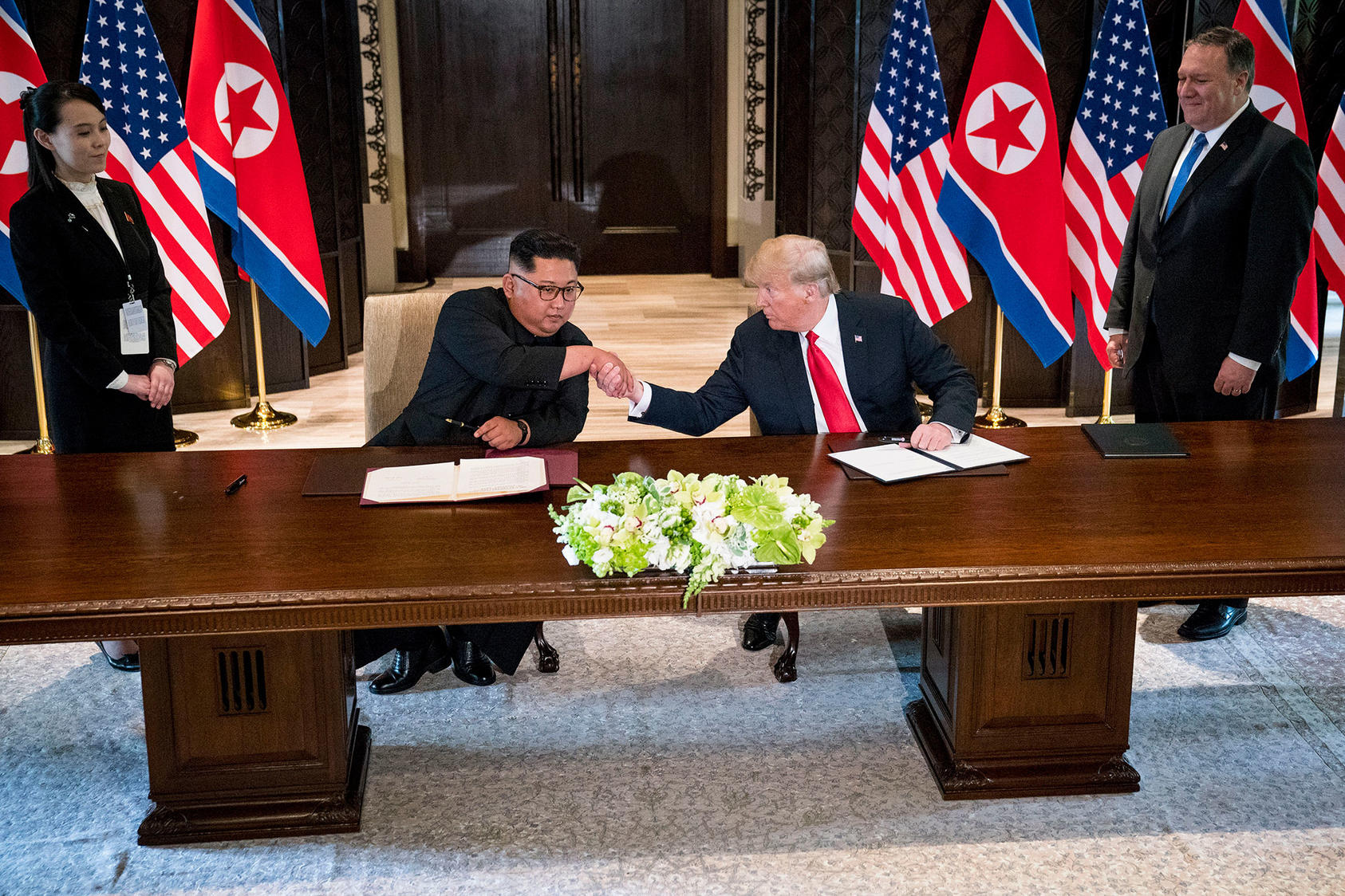 President Donald Trump and Kim Jong Un, North Korea's leader, shake hands during a document signing ceremony on Sentosa Island in Singapore, June 12, 2018. 