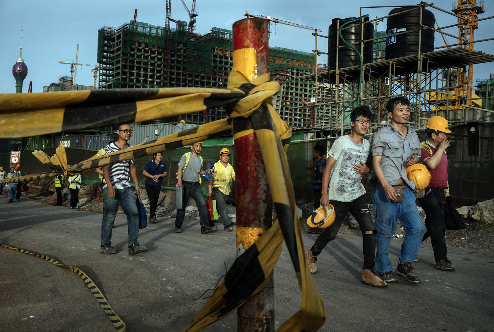 Chinese construction workers walk together after work, in Colombo, Sri Lanka, June 3, 2018. (Adam Dean/The New York Times)