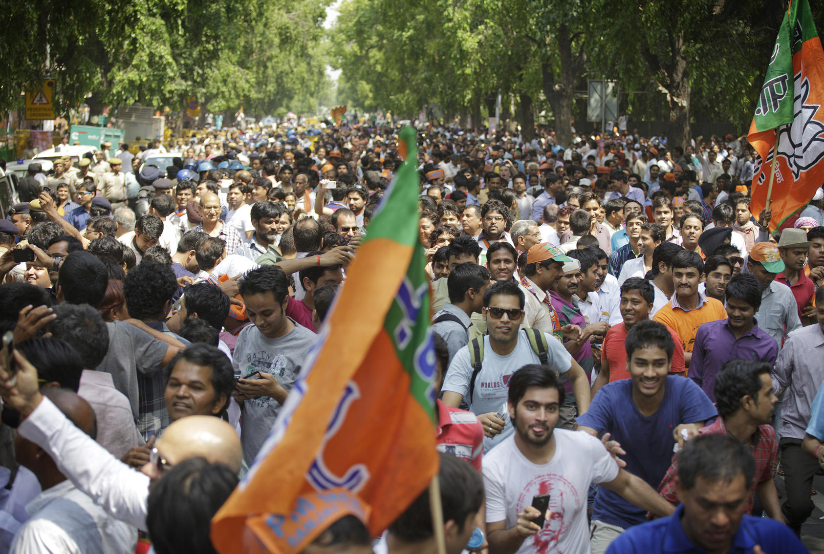 Supporters of Narendra Modi, the winning Bharatiya Janata Party­'s candidate for prime minister, run to follow his motorcade in New Delhi, May 17, 2014. (Kuni Takahashi/The New York Times)