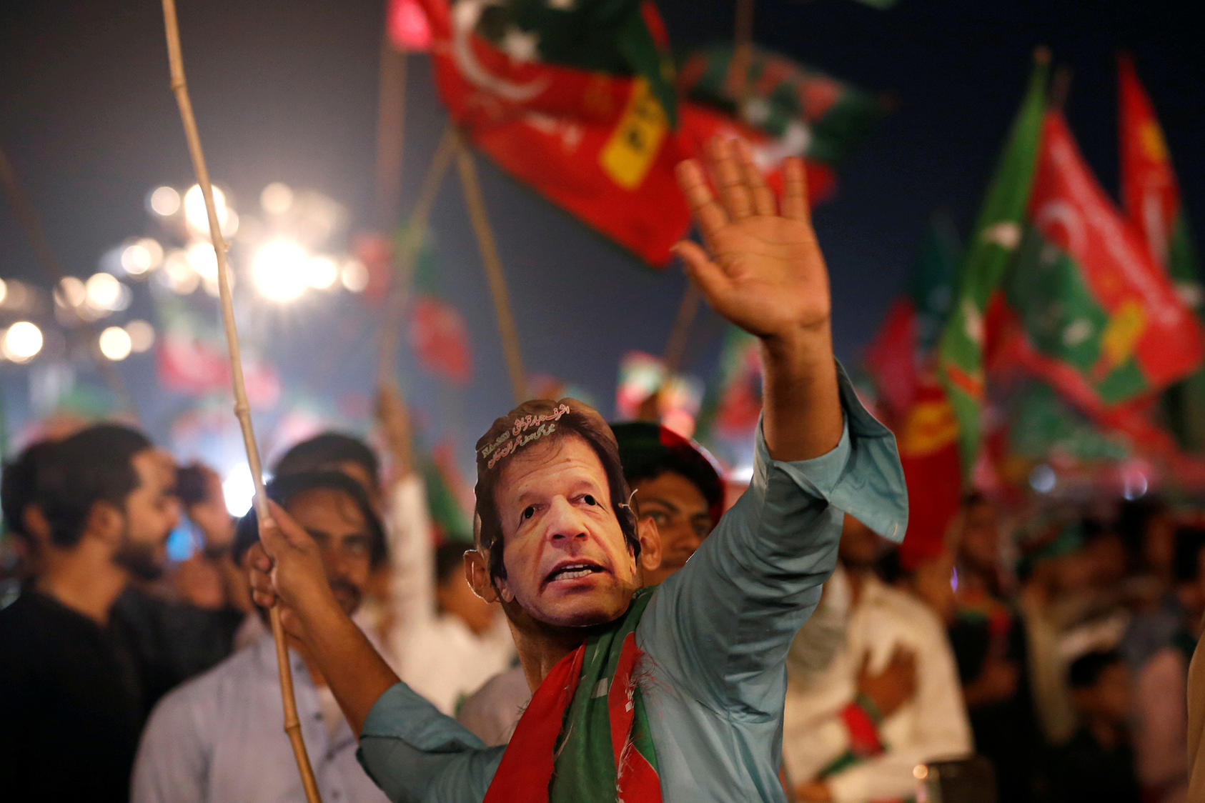 A supporter of Imran Khan, whose Tehreek-e-Insaaf party ultimately won a plurality of legislative seats, wears a mask with Khan’s face during a campaign rally. (Photo by Akhtar Soomro/Reuters)