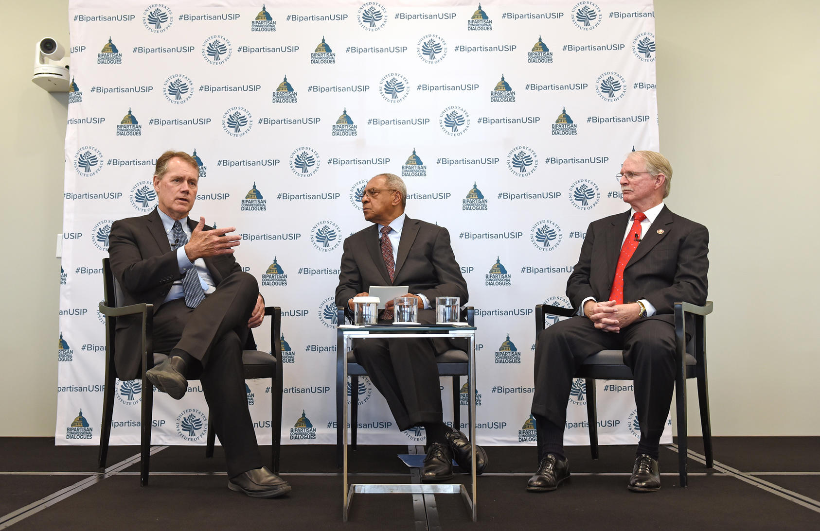 From left to right: Rep. Ed Case (D-HI), USIP’s Amb. George Moose and Rep. John Rutherford (R-FL) at USIP.