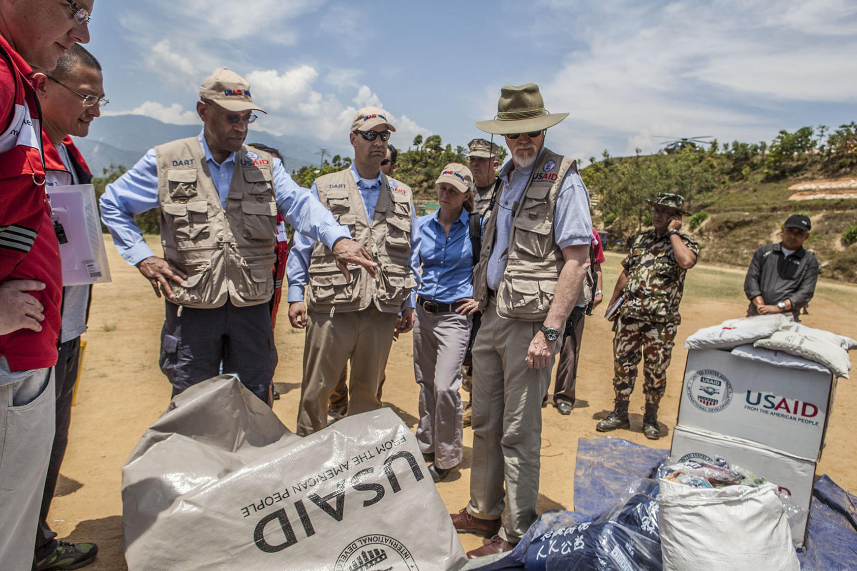 USAID staff are briefed during a visit to Nepal in the wake of a devastating 2015 earthquake. (USAID/Flickr)