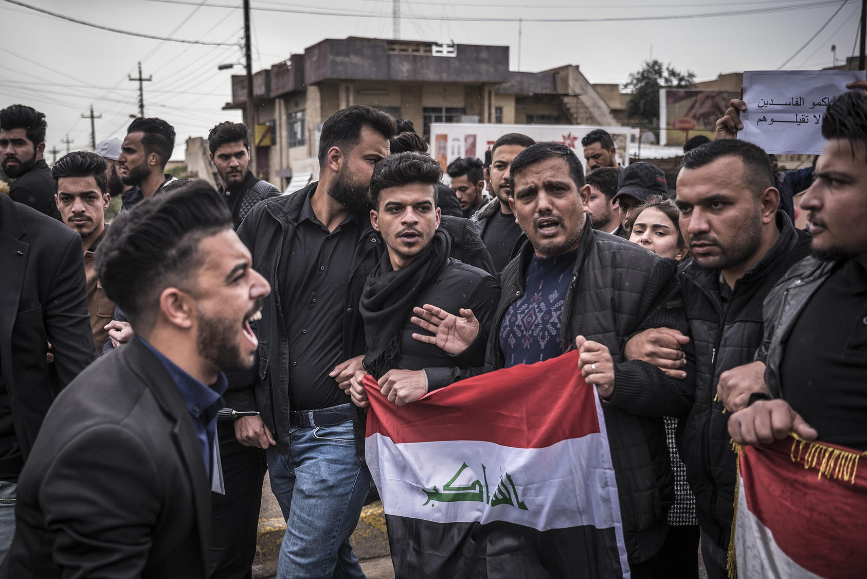 Iraqis chant slogans during a protest in Mosul, March 24, 2019. (Sergey Ponomarev/The New York Times)