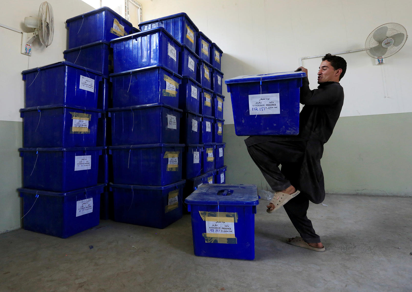 A worker stacks ballot boxes and election materials in a warehouse in Jalalabad for the October 2018 parliamentary elections. (Parwiz Parwiz/Reuters)