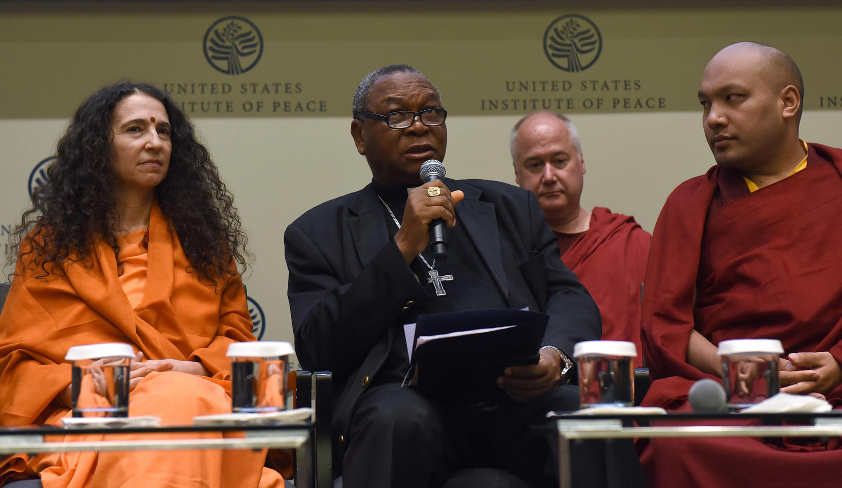 Nigerian Catholic Archbishop John Onaiyekan spoke with Hindu and Buddhist leaders at a 2018 conference on ways to advance religious freedoms. Onaiyekan helps lead a USIP-supported initiative to calm violence committed in the name of religion in Nigeria.