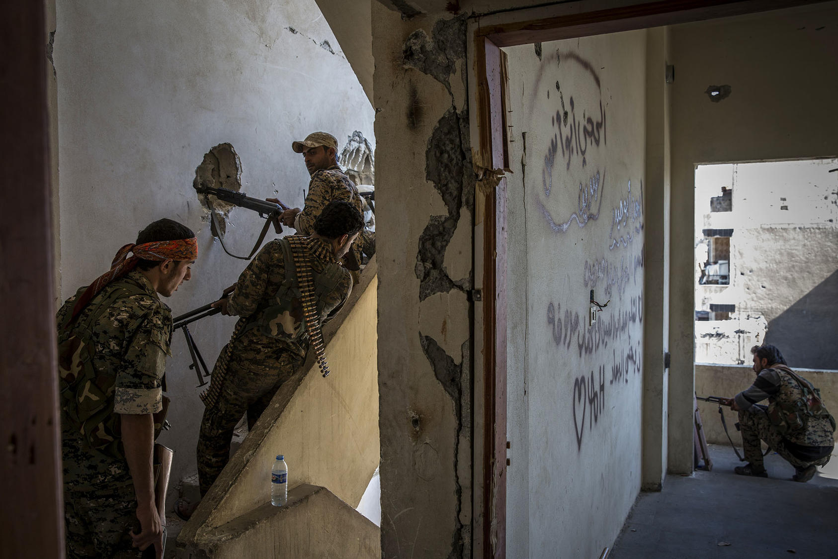 Members of the Syrian Democratic Forces monitor and fire at what they believed were Islamic State fighters in Raqqa, Syria, Oct. 12, 2017. (Ivor Prickett/The New York Times)