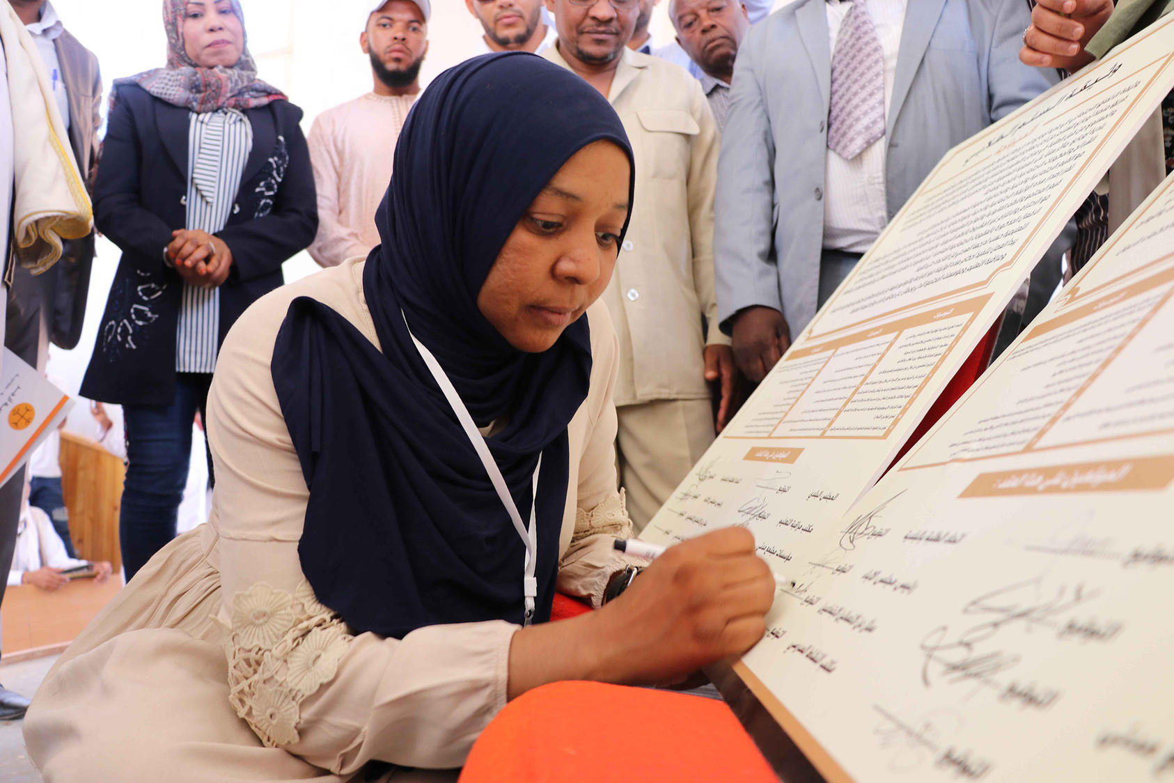 Aisha Abd Al-Nur signs the social pact in Ubari, Libya, Sept. 21, 2019.