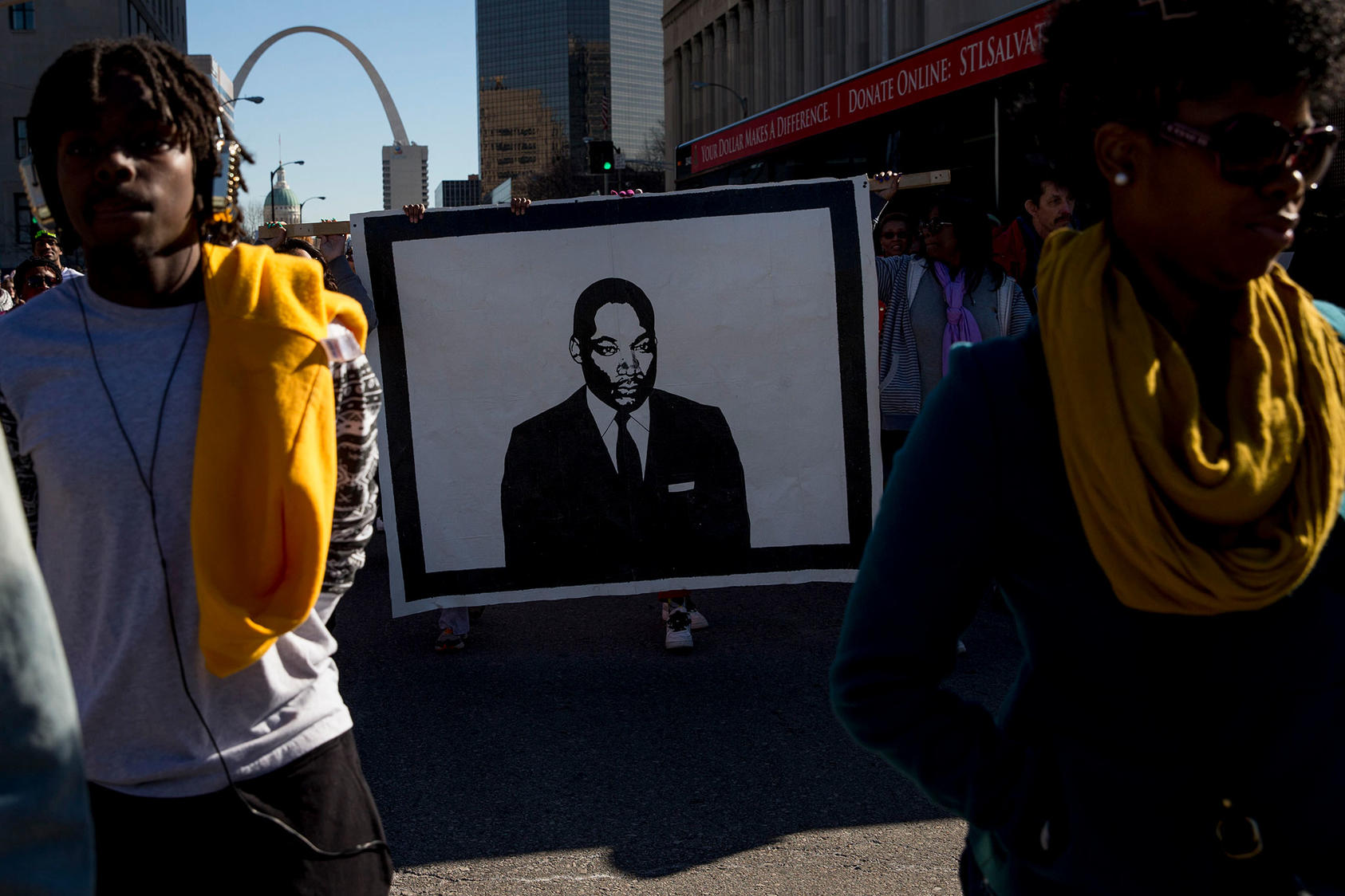 A portrait of Martin Luther King Jr. is carried during a march on the holiday named for him in St. Louis, Missouri, Jan. 19, 2015. (Whitney Curtis/The New York Times)