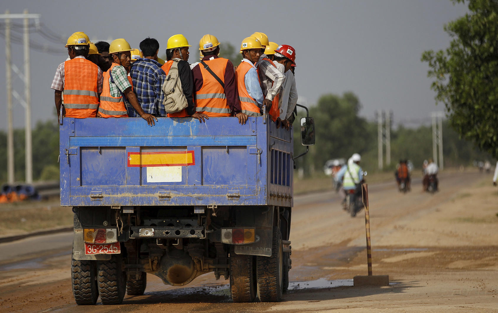 Construction workers ride to the site of the Thilawa Special Economic Zone, approximately fifteen miles south of Yangon, on May 8, 2015. (Soe Zeya Tun/Reuters)