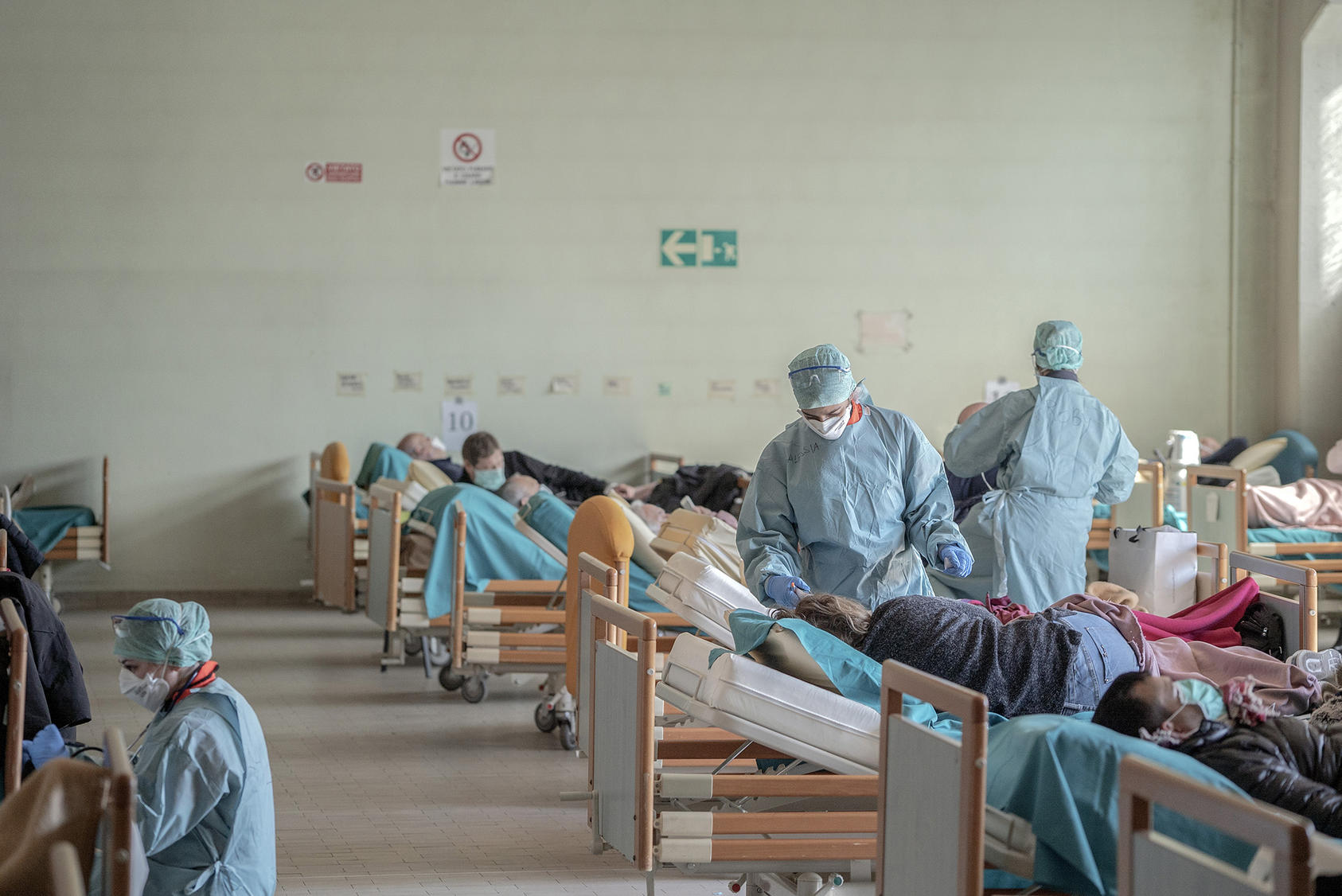 The laundry area of a hospital in Brescia, Italy, filled with beds for patients waiting to be tested for the coronavirus, Monday, March 16, 2020. These types of facilities are largely unavailable in refugee camps. (Alessandro Grassani/The New York Times)