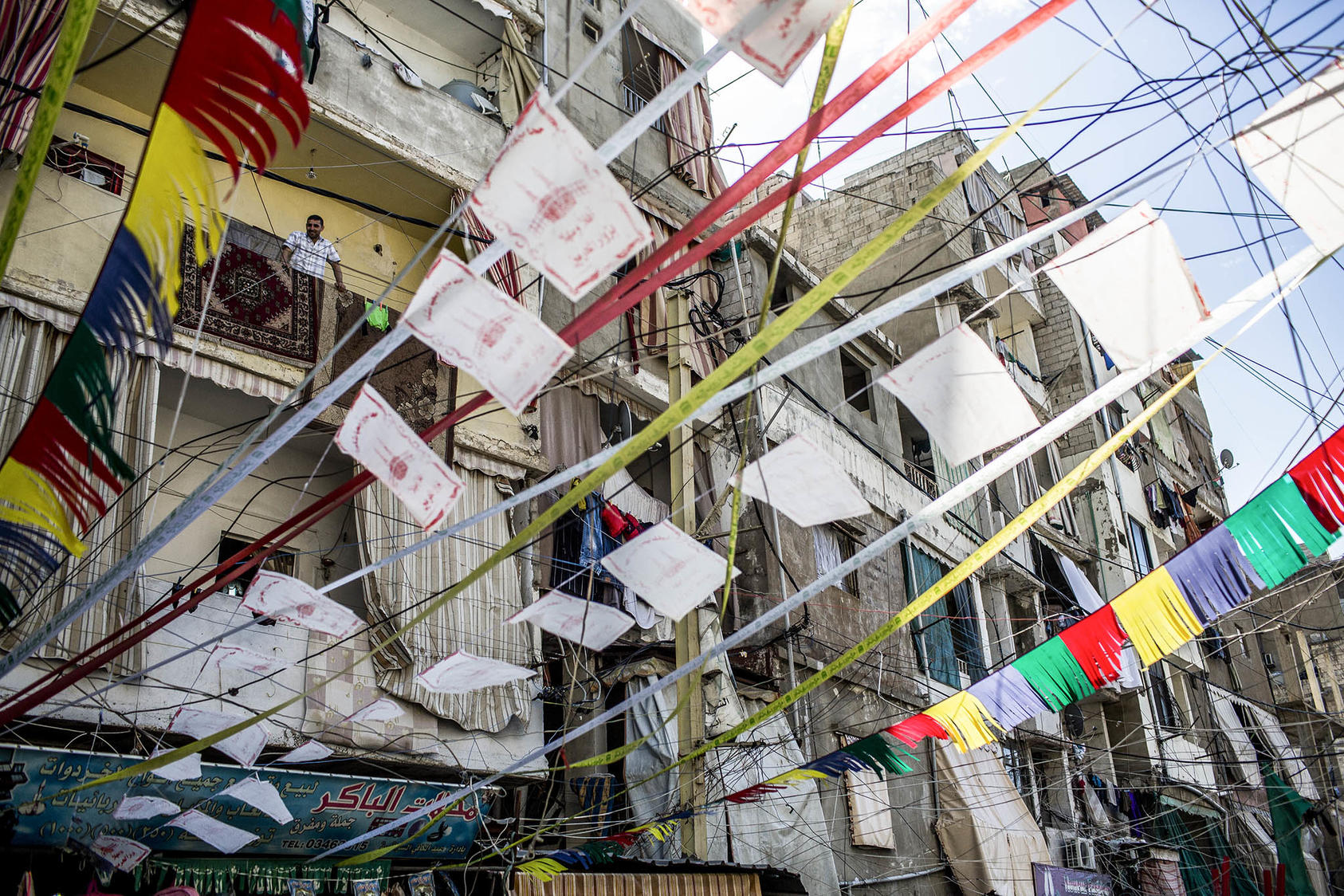 Wires strung from buildings in the Shatila refugee camp near Beirut, Lebanon, where a new wave of Syrian refugees has swollen the population, Oct. 22, 2014.  (Bryan Denton/The New York Times)