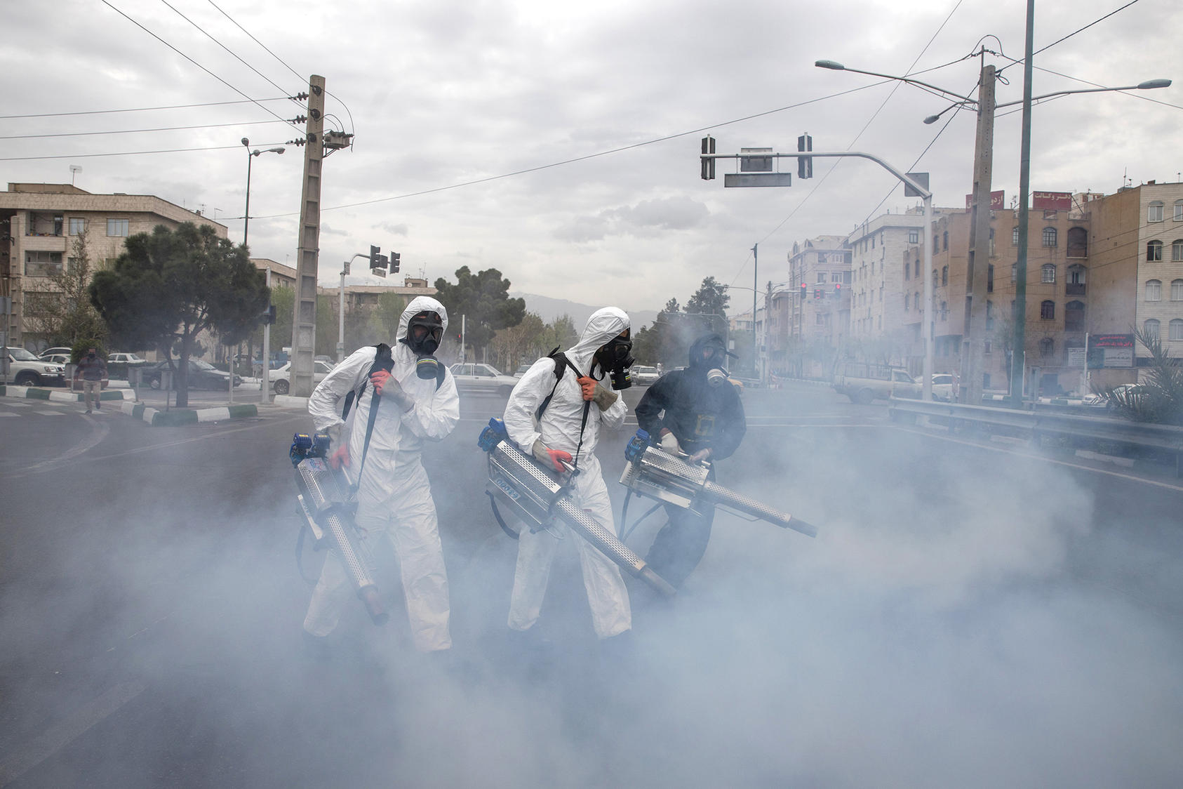 Iranian firefighters disinfect the streets of Tehran, Iran on Wednesday, March 18, 2020. (Arash Khamooshi/The New York Times)