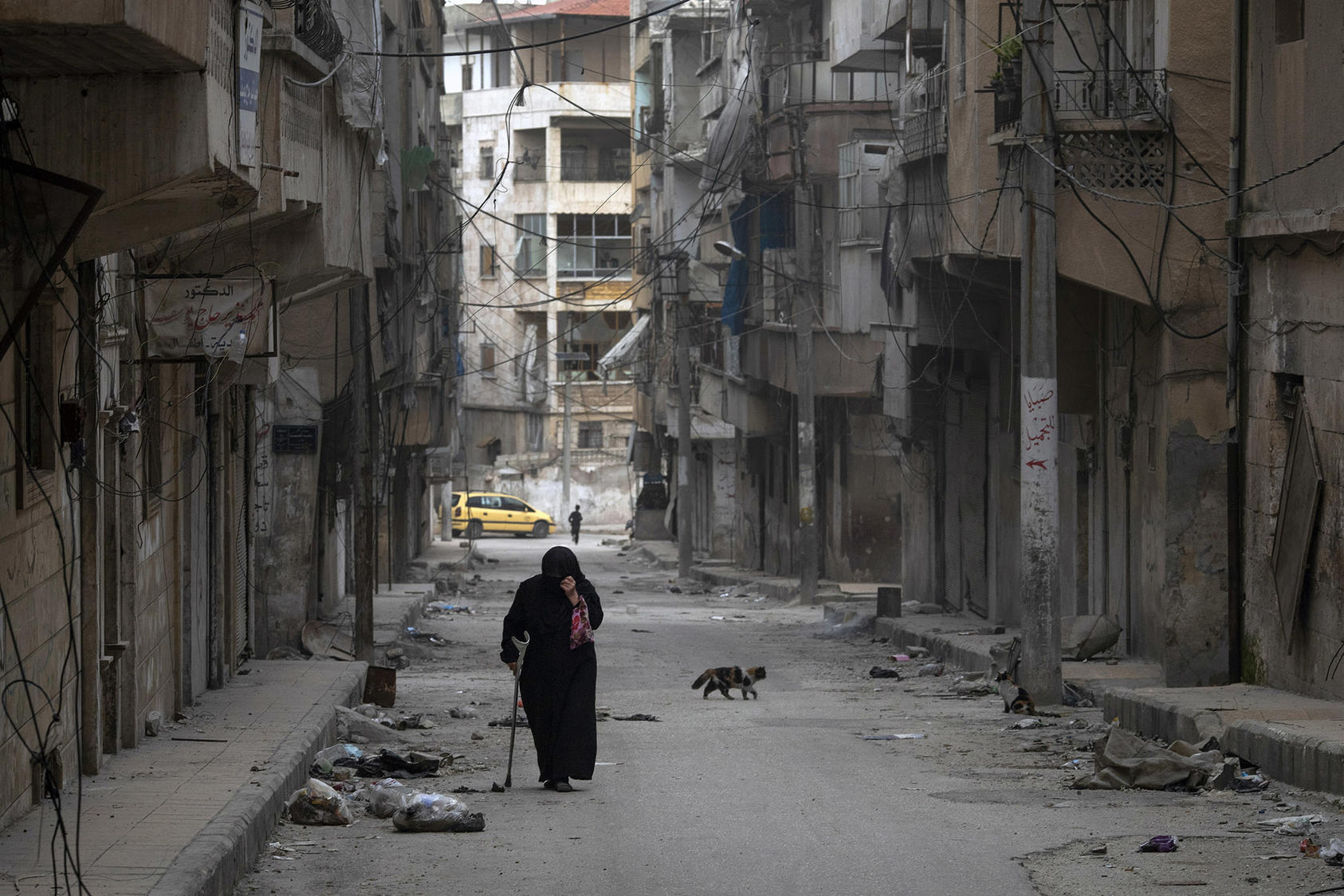 A woman walks down a street in Ariha, in Idlib Province, Syria, on March 12, 2020. (Tyler Hicks/The New York Times)