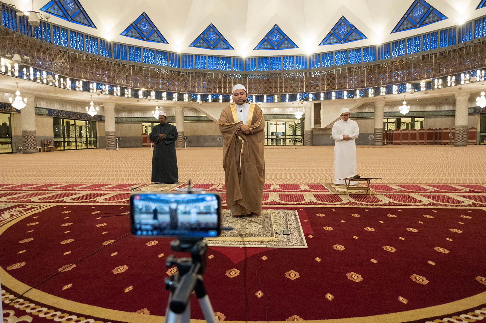 An imam and his assistants perform Tarawih prayer at the National Mosque in Kuala Lumpur, Malaysia, April 24, 2020. (Alexandra Radu/The New York Times)