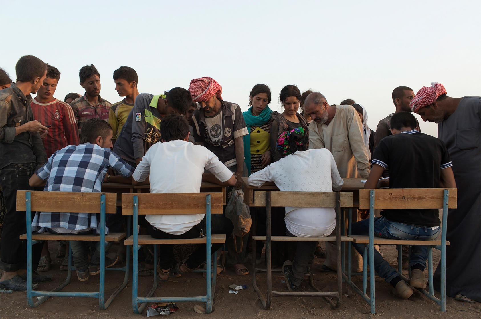 Iraqi Yazidis who have come from the Sinjar mountains register upon arrival at a refugee camp in Derik, Syria, Aug. 10, 2014. (Adam Ferguson/The New York Times)