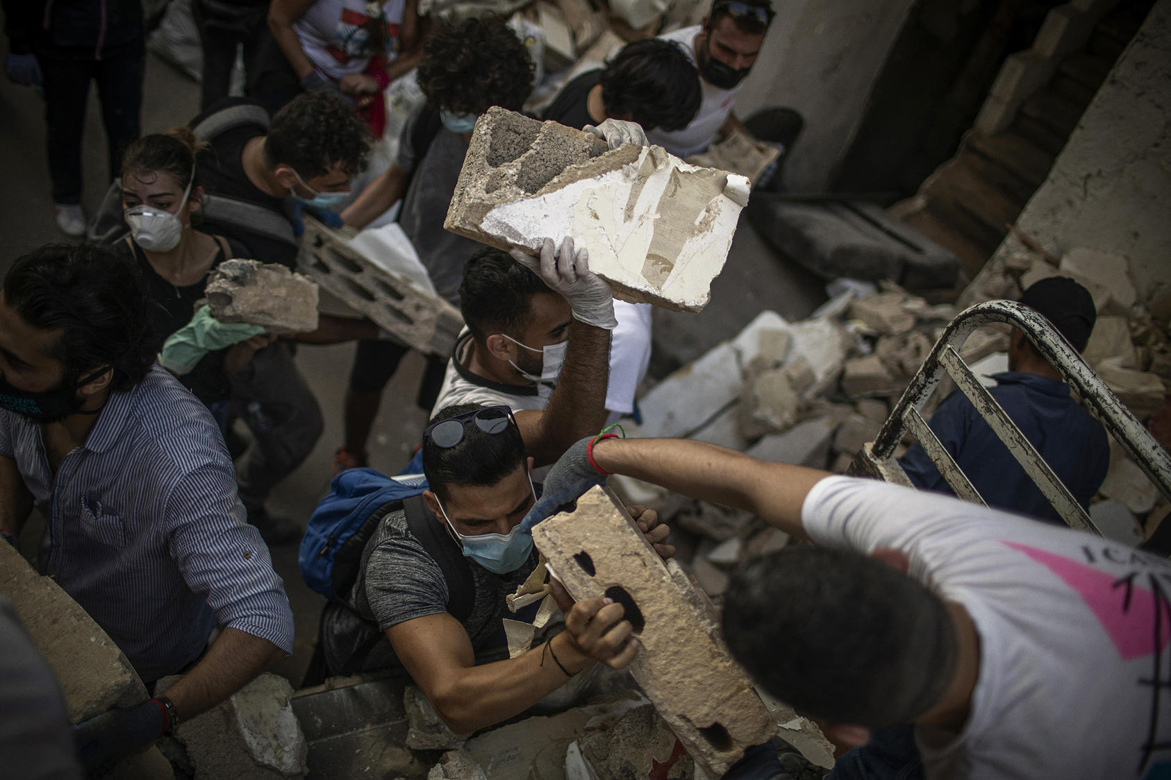 People search through rubble on Thursday, Aug. 6, 2020, in Beirut, resulting from an explosion two days two days after a powerful explosion in Beirut flattened whole neighborhoods in the bustling metropolis. (Diego Ibarra Sanchez/The New York Times)