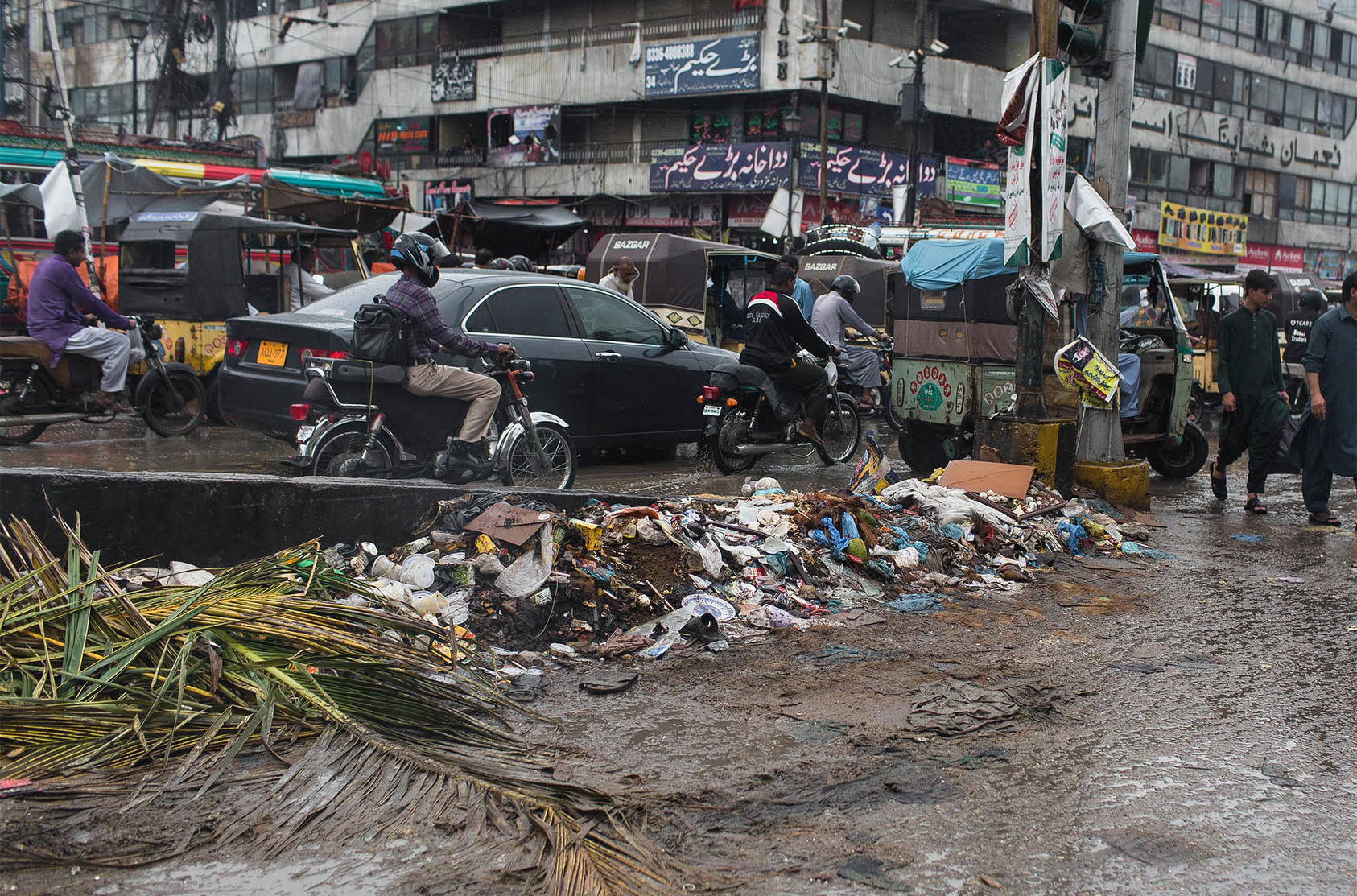 A mound of trash along a street in Karachi, Pakistan after heavy rainfall. Aug. 28, 2019.  (Mustafa Hussain/The New York Times)
