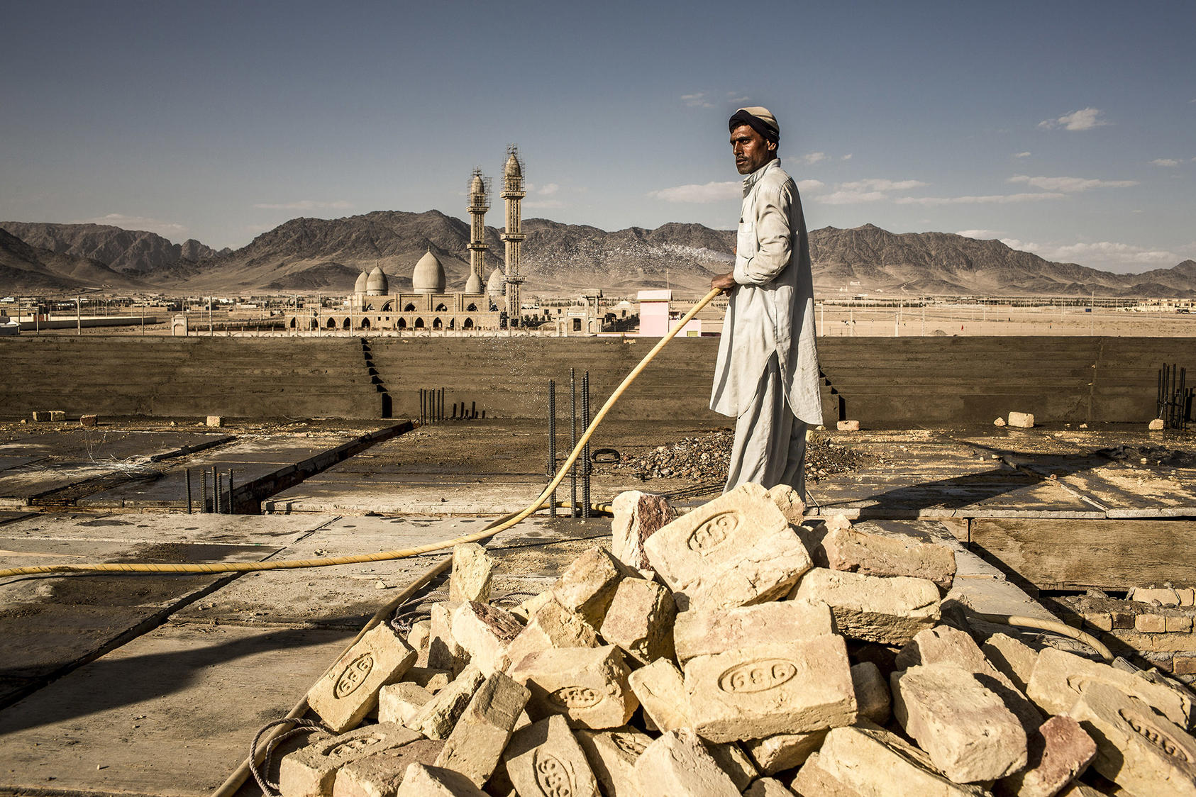 A laborer works on the roof of a large villa under construction in Kandahar, Afghanistan. (Bryan Denton/New York Times)