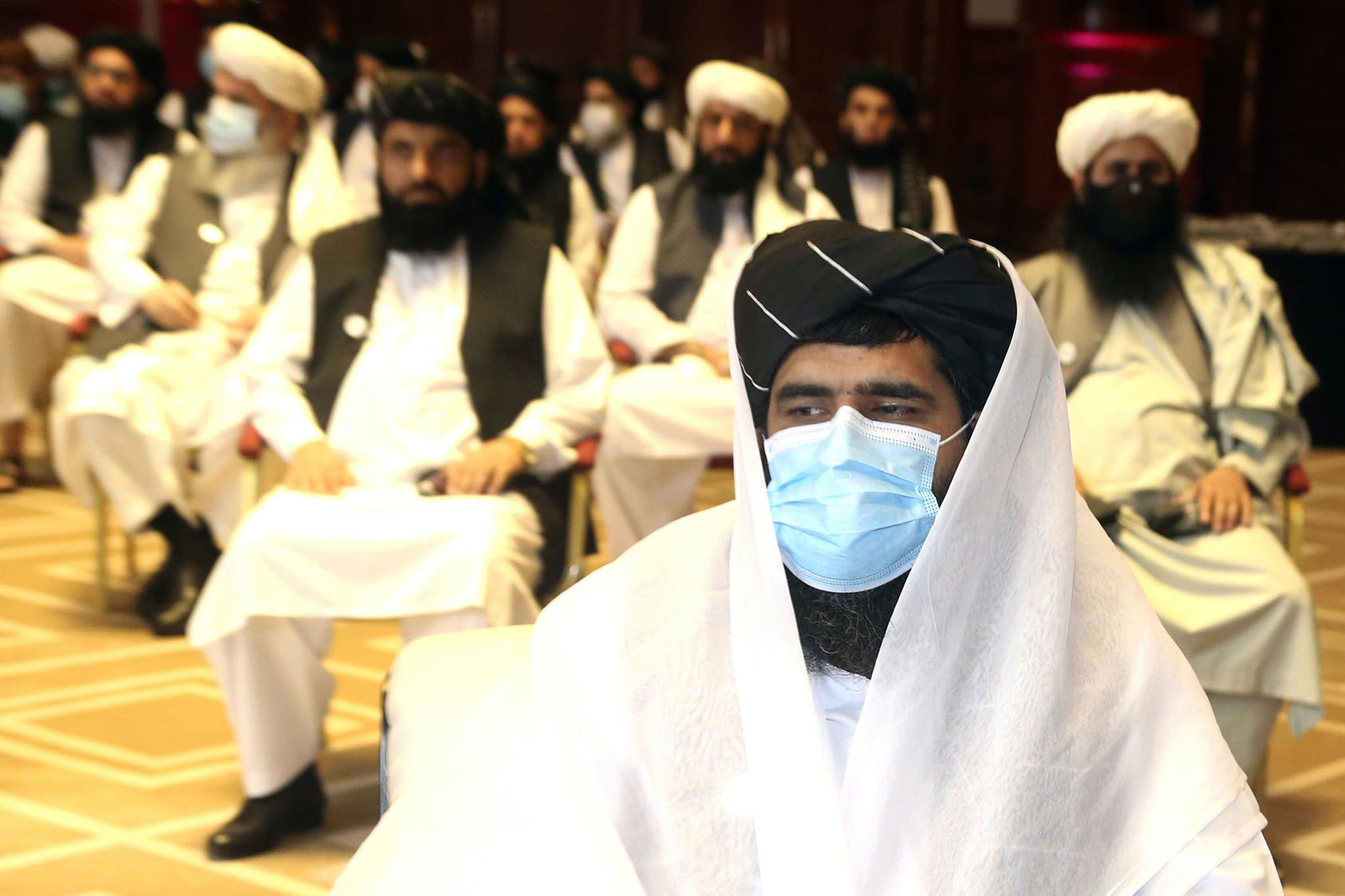 Members of the Taliban negotiation delegation during the opening session of peace talks with the Afghan government in Doha, Qatar, on September 12, 2020. (Photo by Hussein Sayed/AP)