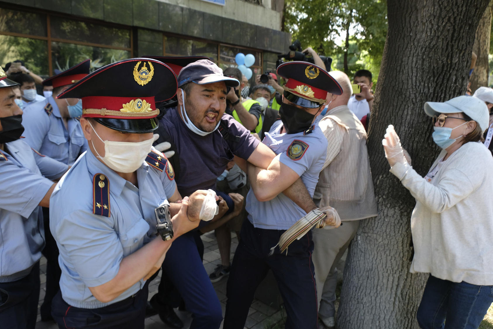 Police wearing face masks to protect against coronavirus detain a protester during an unsanctioned protest in Almaty, Kazakhstan, on June 6, 2020. (Vladimir Tretyakov/AP)