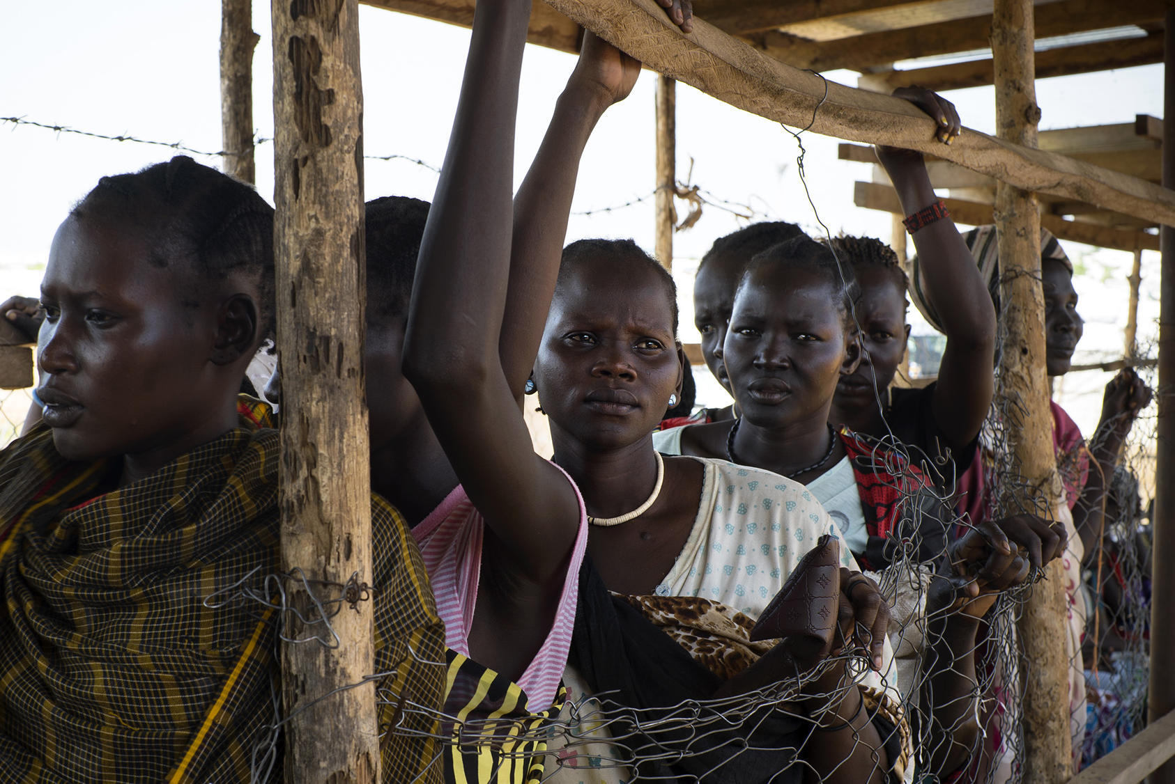 Women wait at a food distribution site in a United Nations camp outside Juba, South Sudan. (Kassie Bracken/The New York Times)