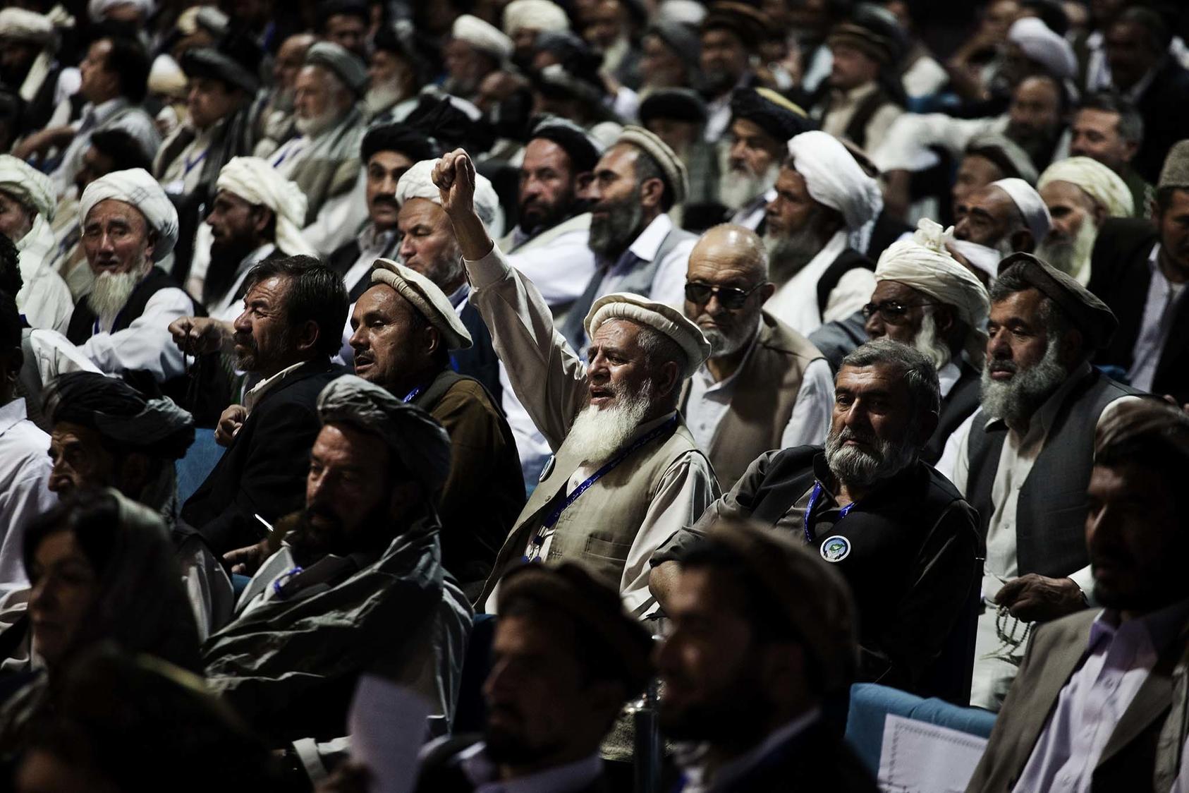 Delegates listen to talks at a national peace convention in Kabul, Afghanistan, on June 4, 2010. (Adam Ferguson/The New York Times)