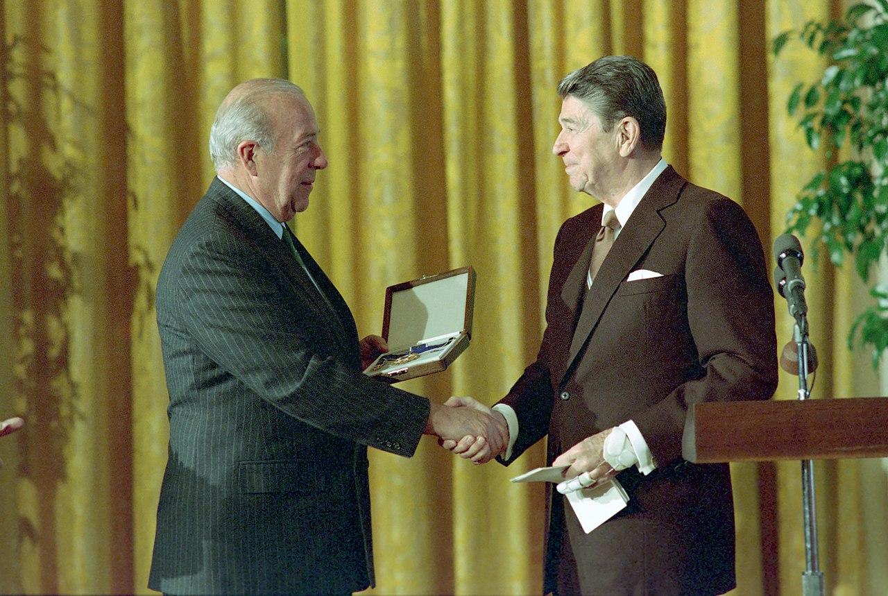 President Ronald Reagan Presenting Medal to George Shultz During The Medal of Freedom Luncheon in The East Room, 1/19/1989