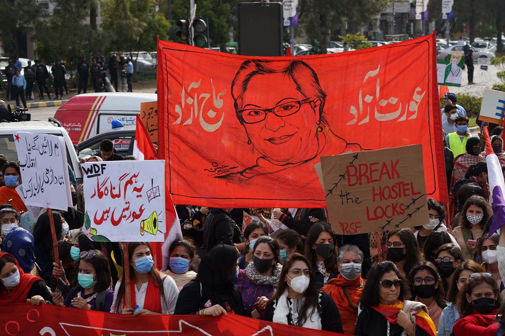 Women rally at the 2021 Aurat March in Islamabad with a banner memorializing Asma Jahangir, a long-prominent human rights activist. (Hassan Turi/Aurat Azadi March)
