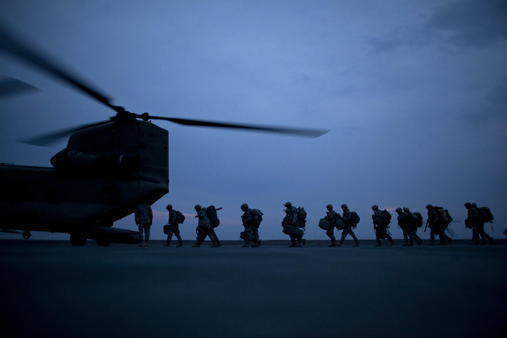 Soldiers board a transport helicopter in Kunduz, Afghanistan, March 6, 2011. What no one knew in 2001 was that invasion to rout al-Qaida, and its hosts, the Taliban, from Afghanistan would turn into a 20-year war.  (Damon Winter/The New York Times)