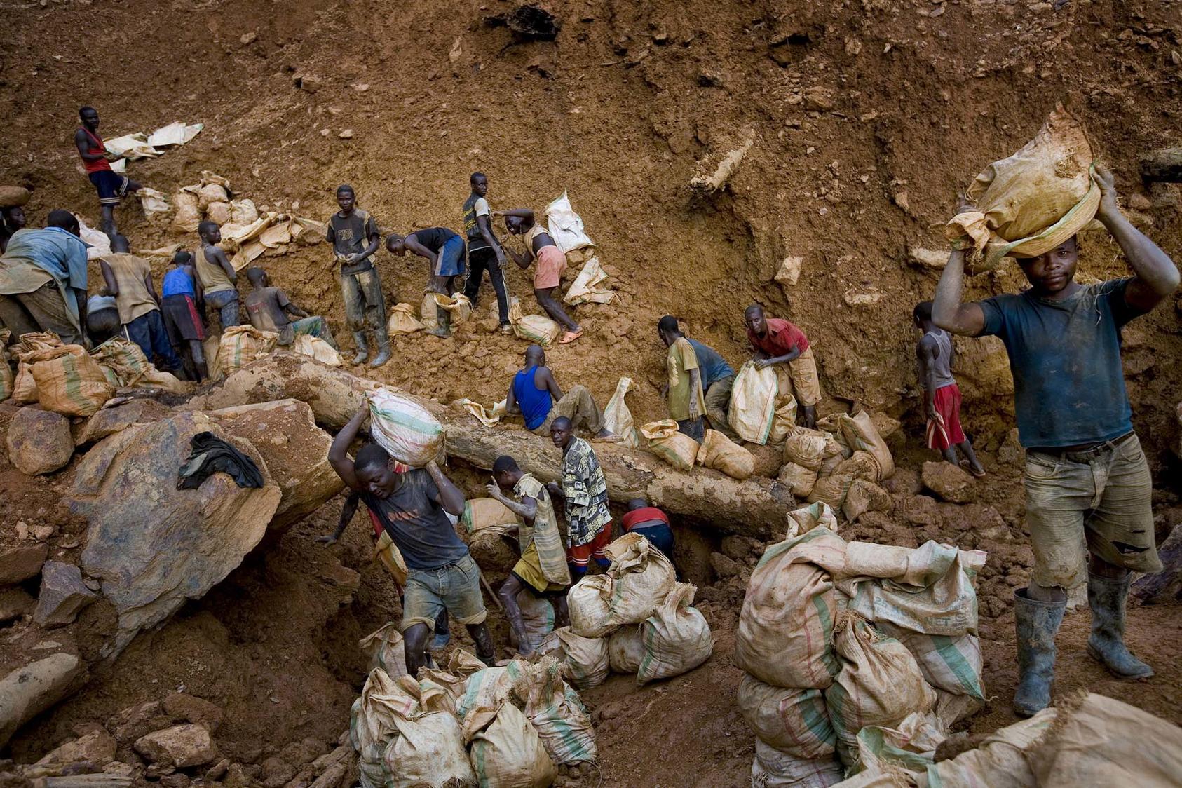Men dig in the Bisie tin mine in the Democratic Republic of the Congo. The mine, like many, has been the object of conflict, with residents suffering from the violence and benefiting little from the mine’s revenues. (Johan Spanner/The New York Times)