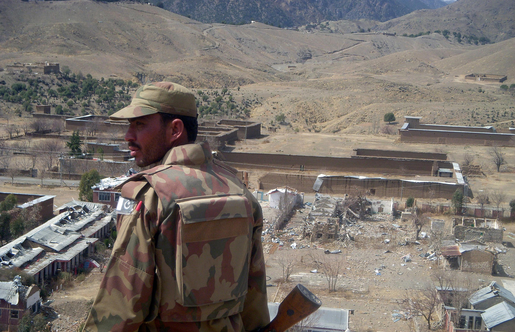 A Pakistani soldier surveys what used to be the headquarters of Baitullah Mehsud, the TTP leader who was killed in March 2010. (Pir Zubair Shah/New York Times)
