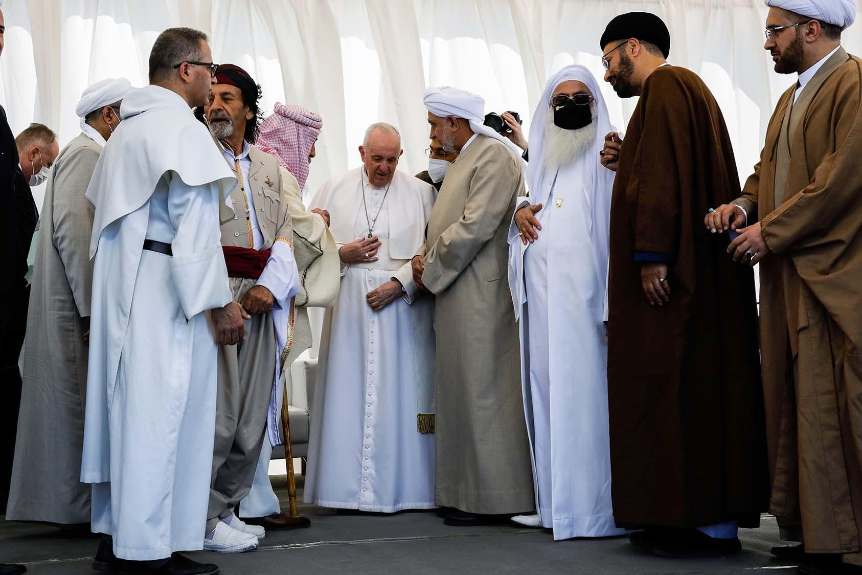 Pope Francis, center, meets leaders of varied faiths during his visit to Iraq in March. He presses religious communities to urgently repair COVID’s harms to human welfare and warns of the “risk of misinformation” online. (Ivor Prickett/The New York Times)