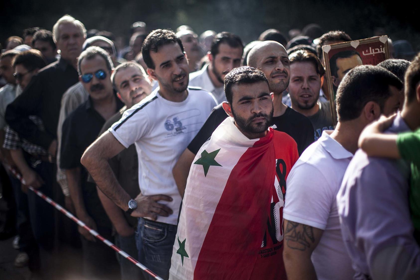 Syrian expatriates wait in long lines to register and vote at their embassy just outside Beirut, in Baabda, Lebanon, May 28, 2014. (Bryan Denton/The New York Times)