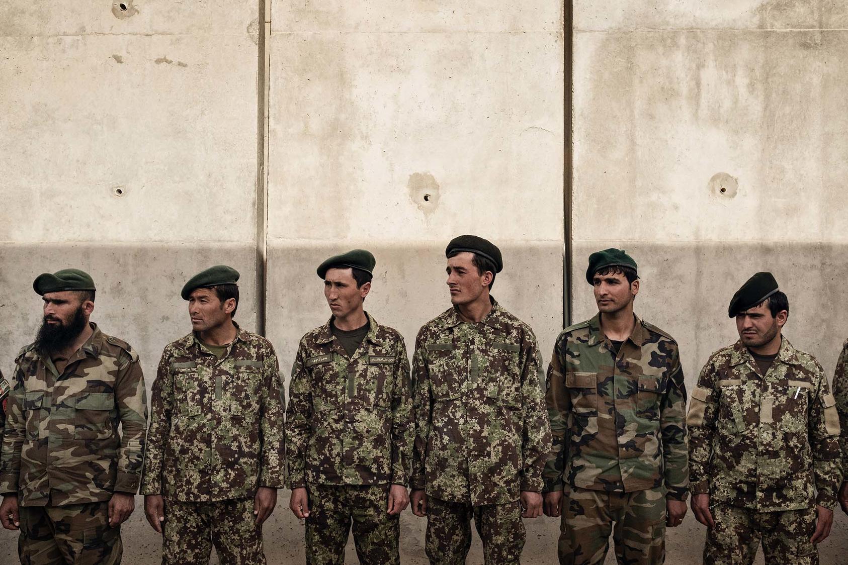 Members of the Afghan National Army stand at attention at Camp Bastion in Helmand Province, Afghanistan, March 21, 2016. A 2016 investigation found that 40 percent of the Afghan troops supposedly fighting in Helmand either did not exist or were dead. (Adam Ferguson/The New York Times)