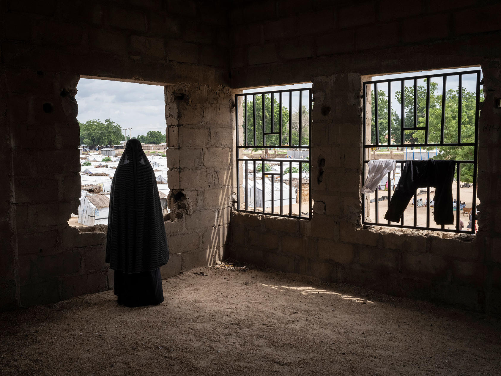 A woman who was kidnapped by Boko Haram and was recruited as a bomber, stands for a portrait, Aug 2019, at Konduga IDP camp. About 3.3 million of Nigeria’s 211 million people are displaced amid the country’s turmoil. (Laura Boushnak/The New York Times)