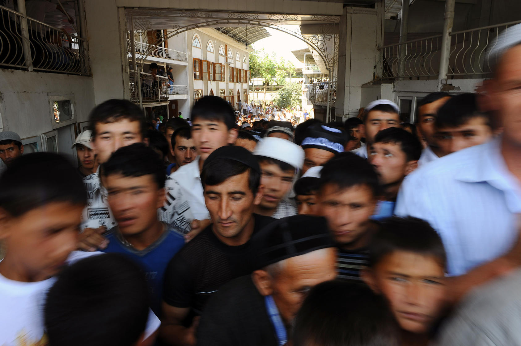 Men and boys leave a mosque in Kyrgyzstan’s border town of Kara-Suu, where residents protested in April amid land disputes with Uzbekistan. Those nations, plus Tajikistan, have had violent clashes at their disputed borders. (James Hill/The New York Times)